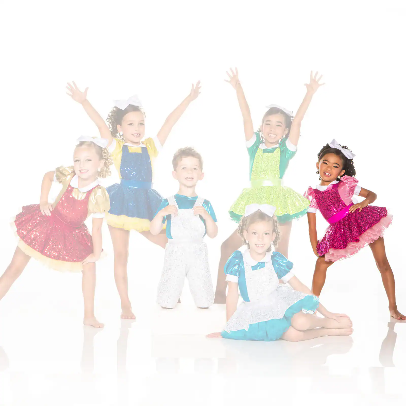 Children posing in colorful sequined dance costumes