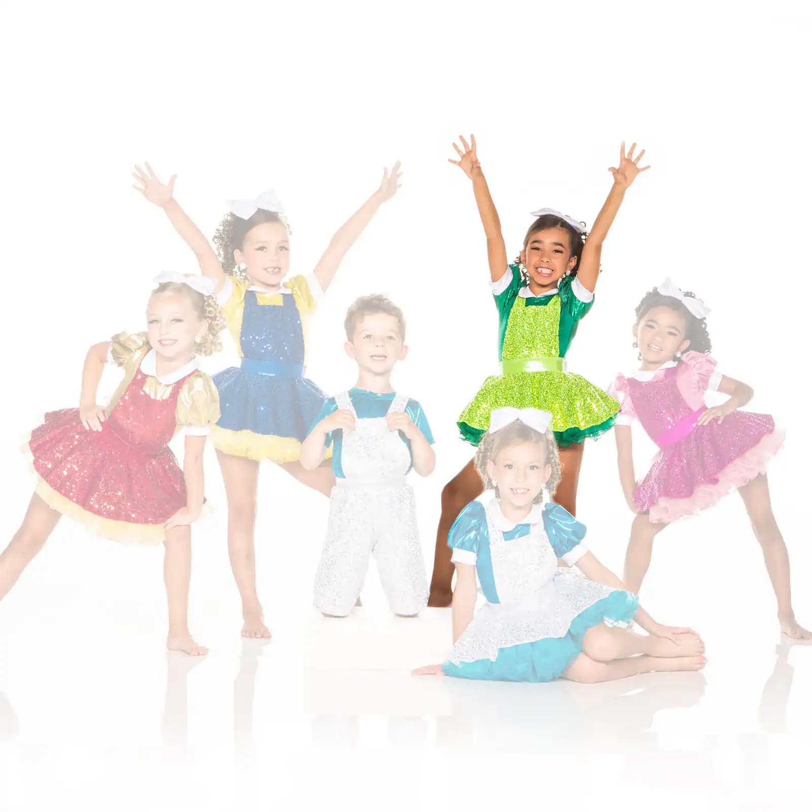 Six children posing in colorful glitter dance costumes