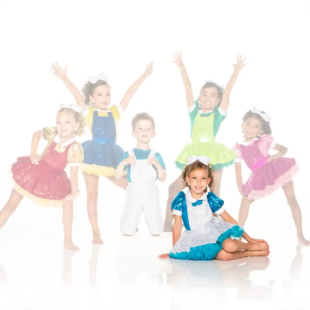 Six children in colorful sequined dance costumes posing