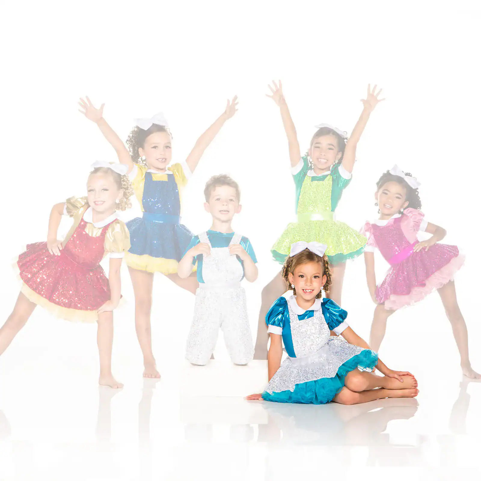 Six children in colorful sequined dance costumes posing