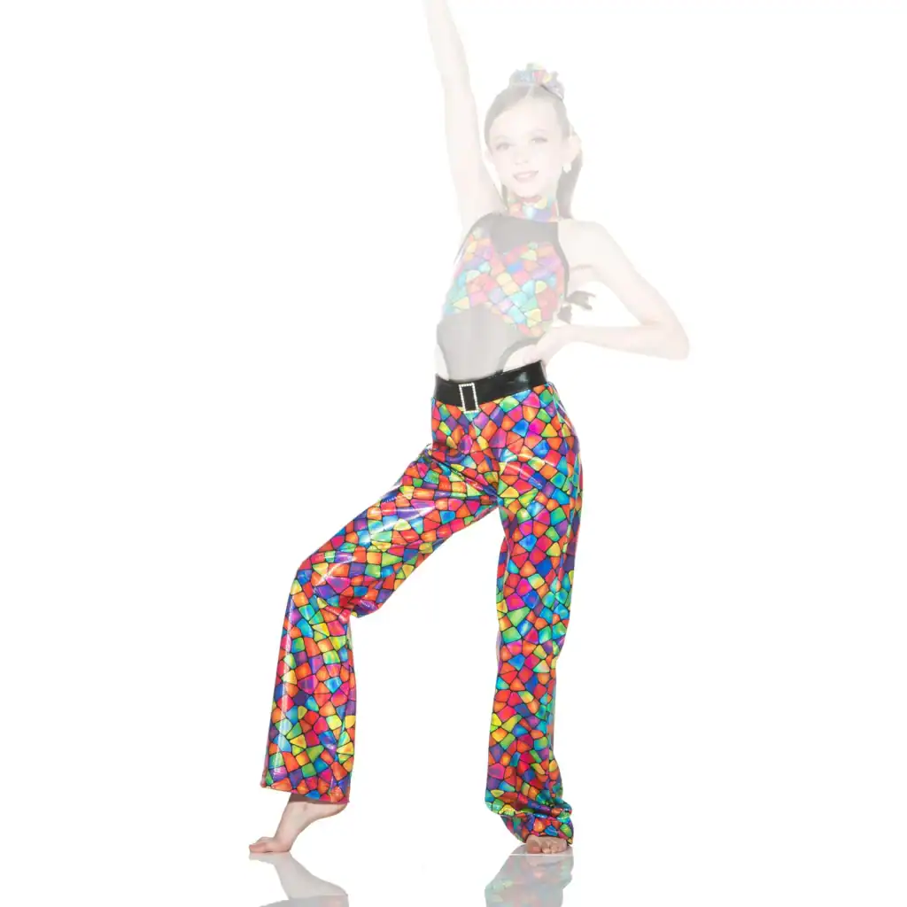 Young dancer poses in colorful mosaic-patterned costume.