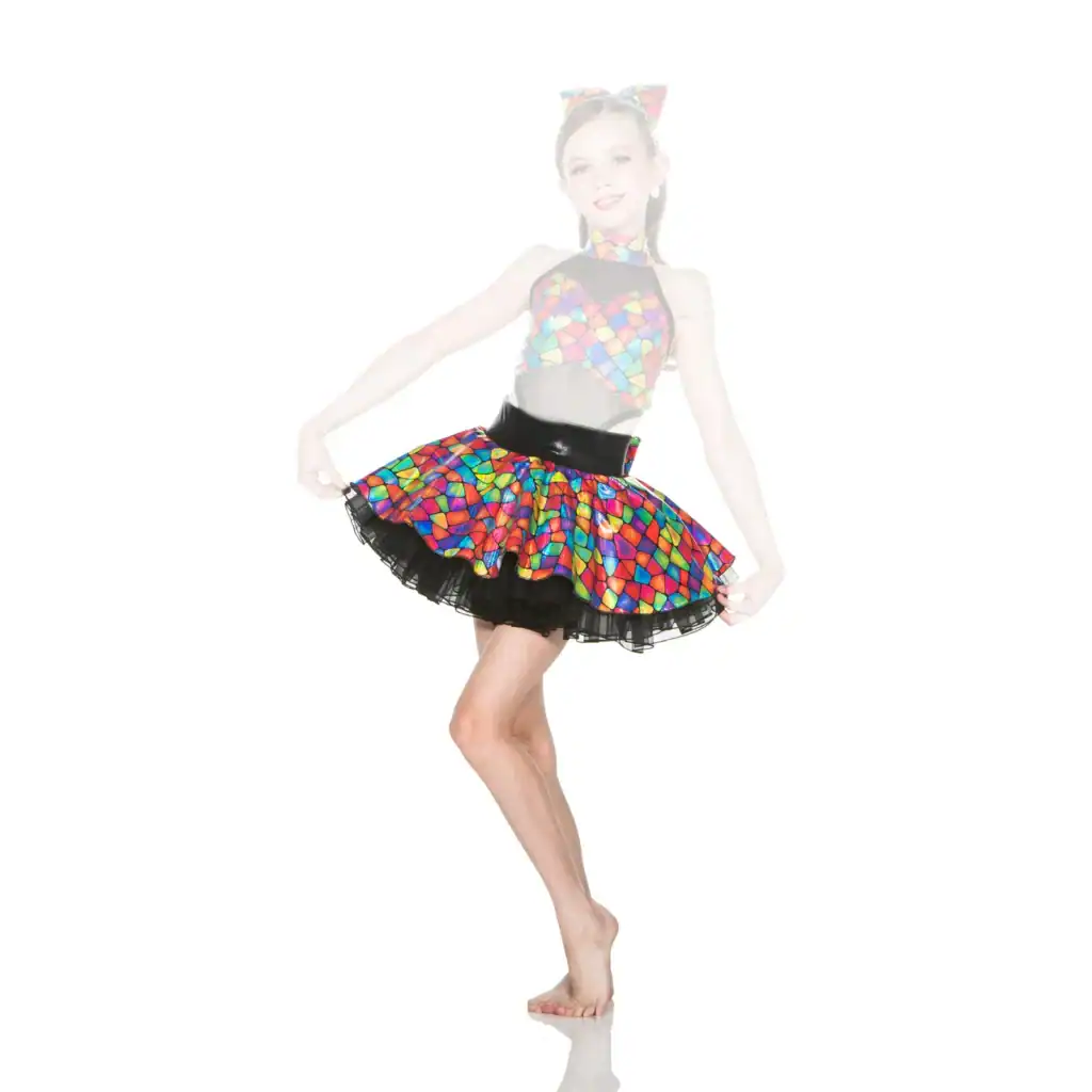 Girl wearing colorful mosaic-patterned dance costume poses barefoot