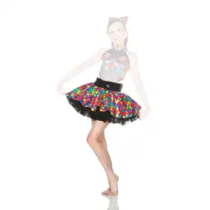 Girl wearing colorful mosaic-patterned dance costume poses barefoot