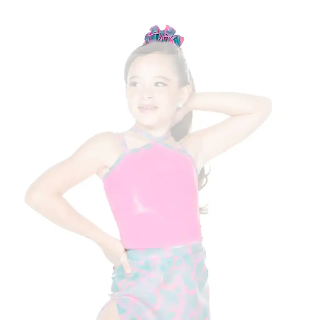 Young girl posing in pink dance costume with hair bow
