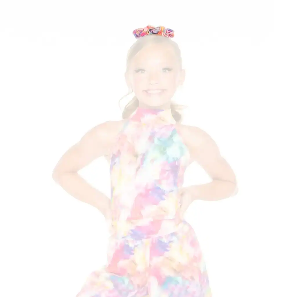 Smiling girl wearing a colorful tie-dye outfit and scrunchie