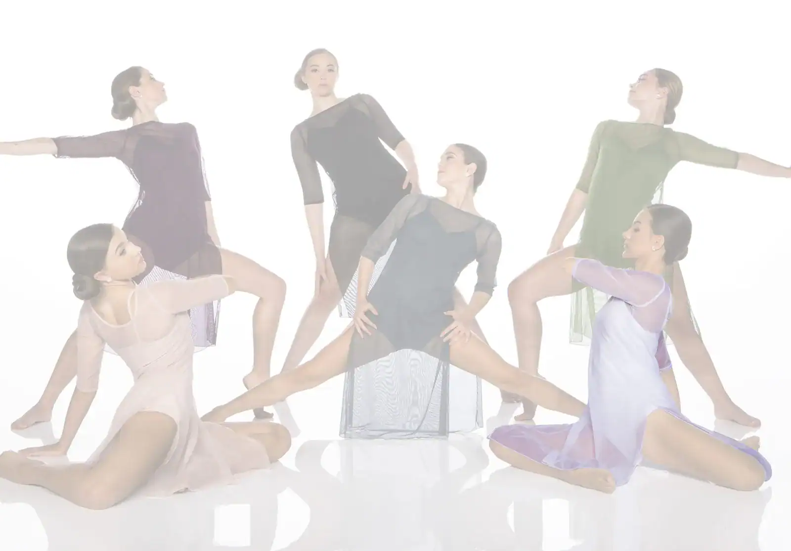 Six contemporary dancers pose in flowing dresses against white backdrop.