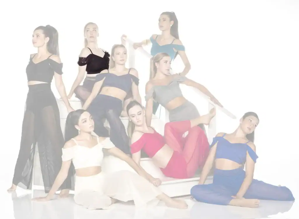 Nine women pose stylishly on a white staircase.