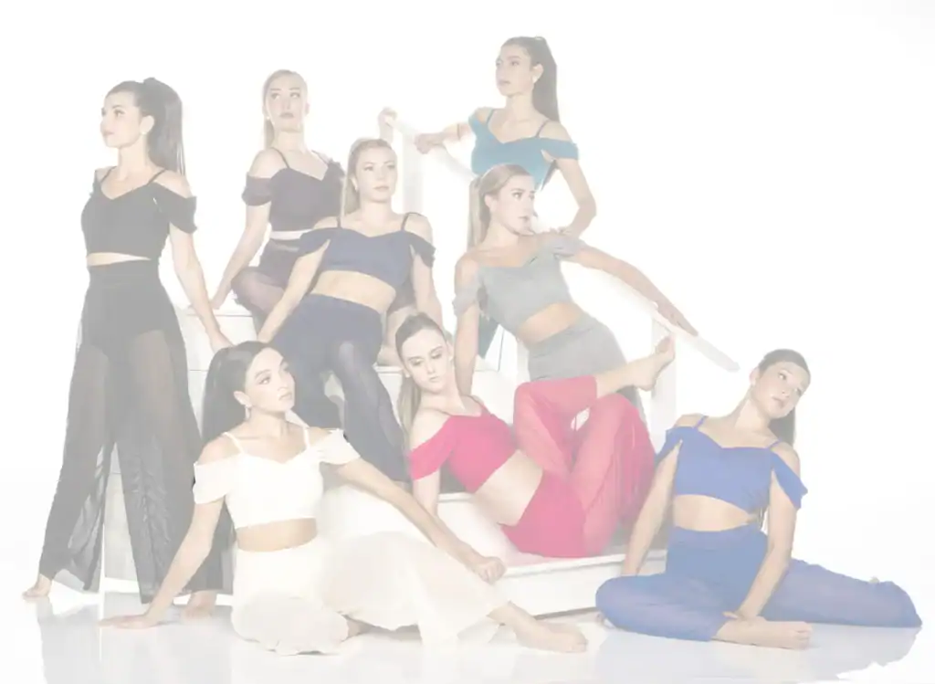 Eight women posing in colorful outfits on white stairs