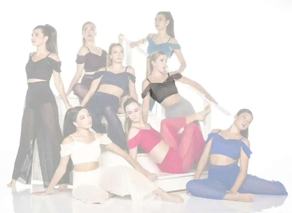 Eight women pose in colorful dance outfits on white stairs.