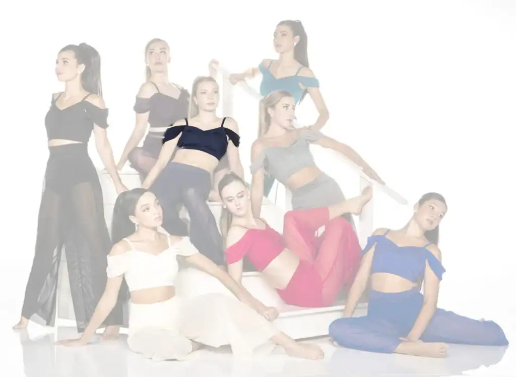 Eight women pose on stairs in colorful coordinated outfits.