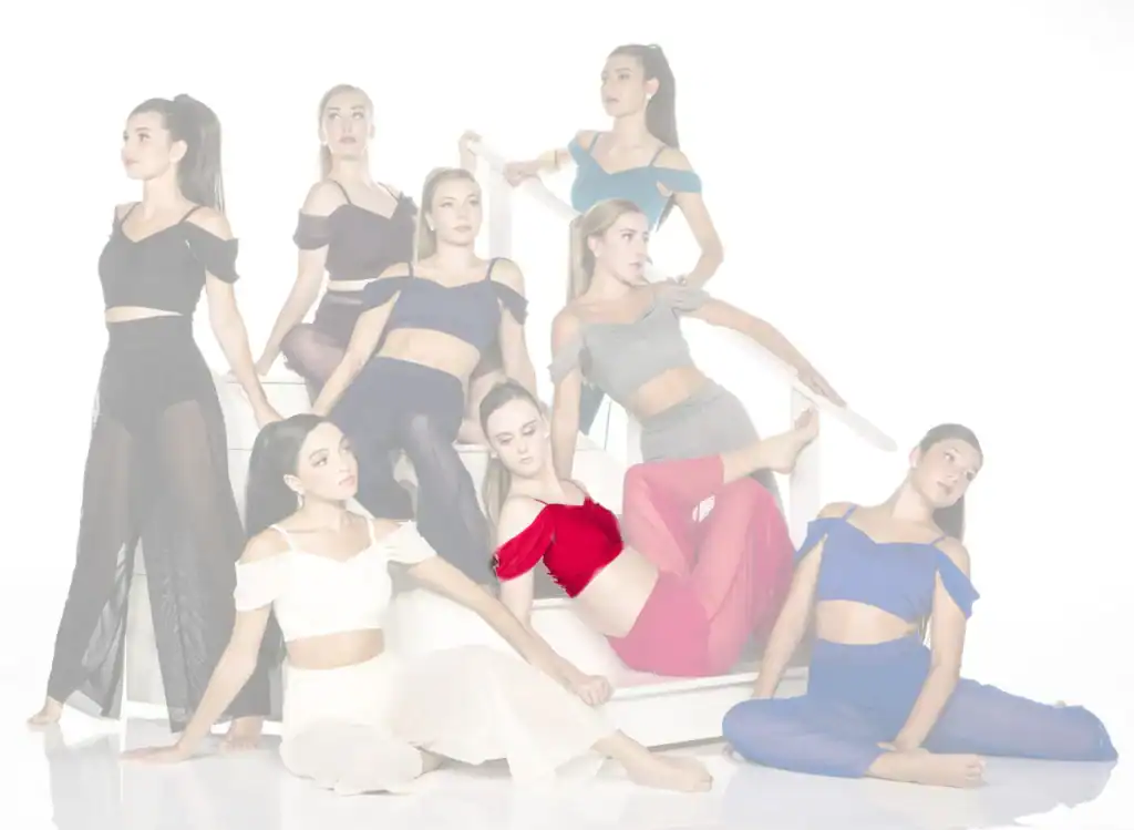 Eight dancers pose on white stairs in colorful outfits.