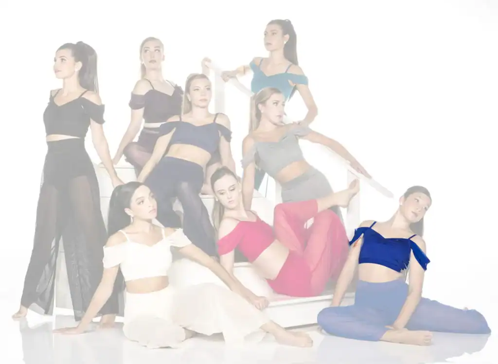 Eight women posing on white stairs in colorful dancewear