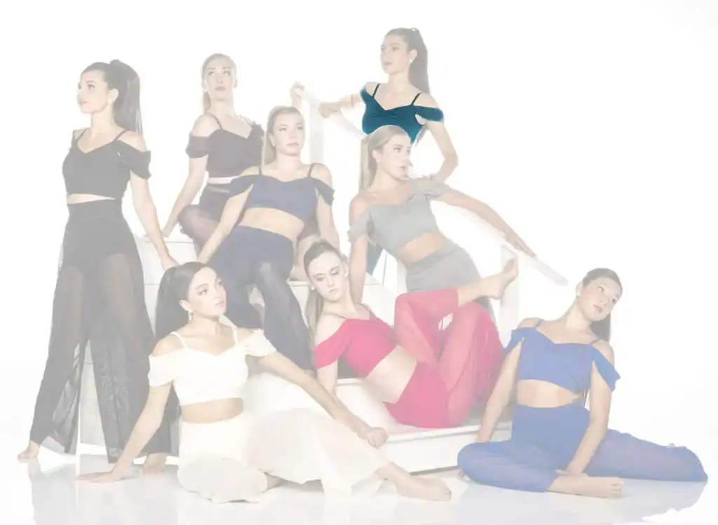 Eight women pose in colorful outfits on white stairs.