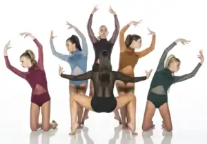 Five dancers pose in colorful sheer leotards against white background.