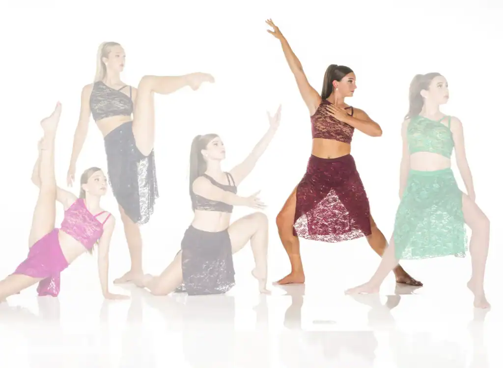 Five dancers pose in colorful lace dance costumes.