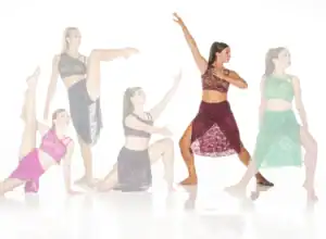 Five dancers pose in colorful lace dance costumes.