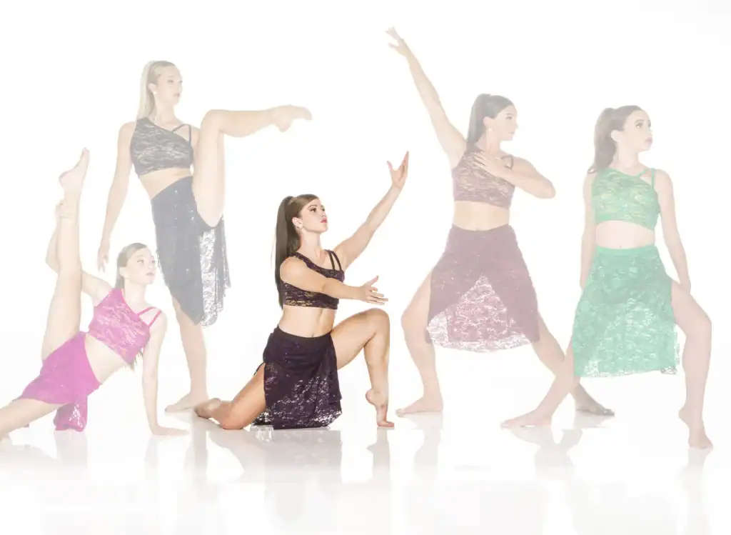 Five dancers posing in colorful lace costumes