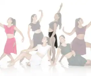 Six women in colorful outfits pose as dancers.