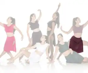 Six women dancers posing in colorful outfits