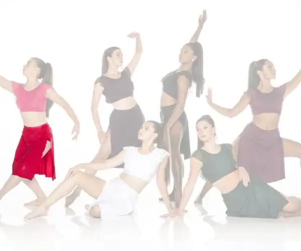 Six female dancers posing in colorful contemporary costumes