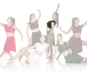 Six dancers posing in colorful costumes against a white background
