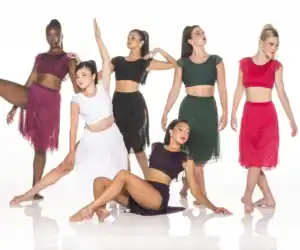Six dancers pose in colorful two-piece costumes.