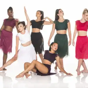 Six dancers pose in colorful two-piece costumes.