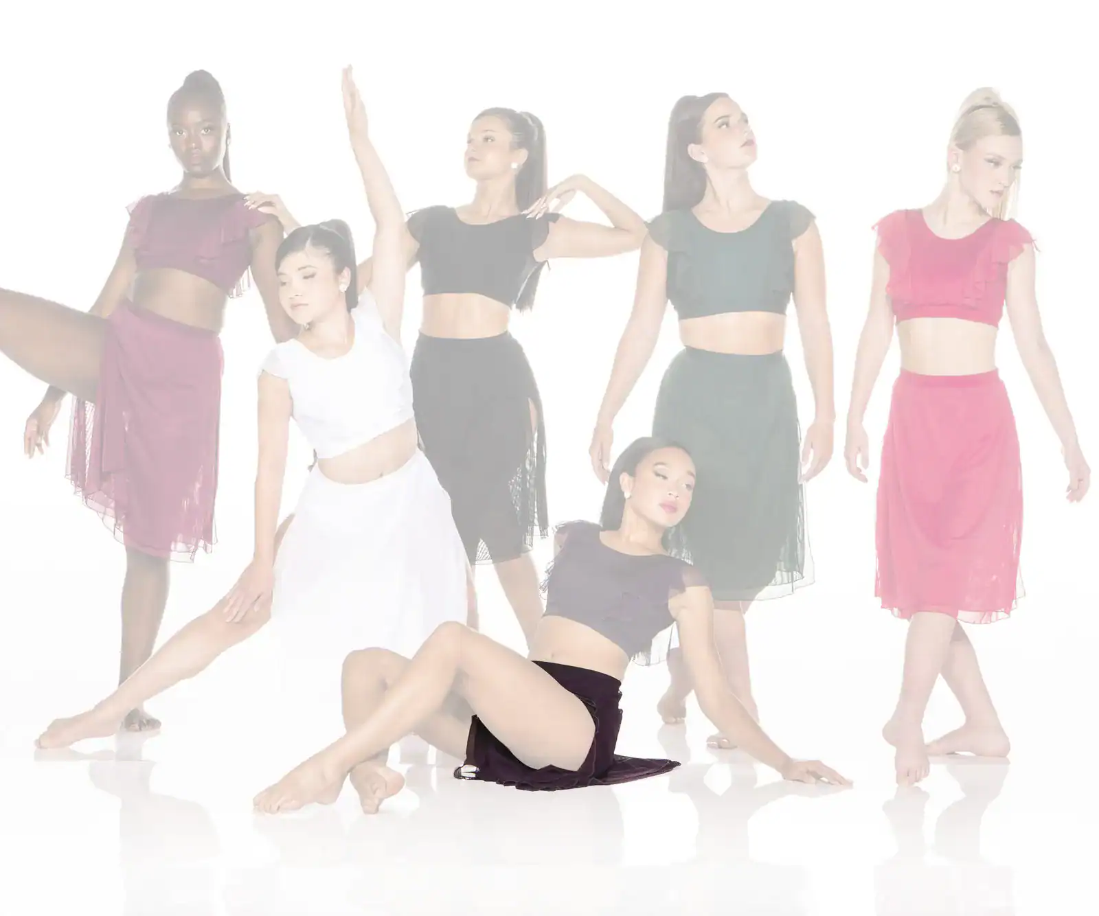 Five dancers posing in colorful costumes against white background