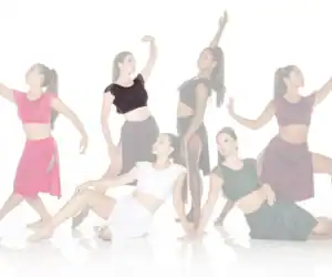 Six dancers posing in colorful costumes against white background