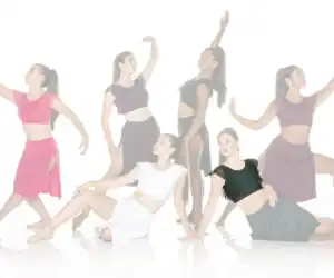 Six women dancers posing in colorful crop tops and skirts