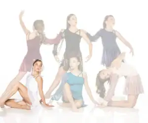 Five female dancers pose in colorful costumes against white background.