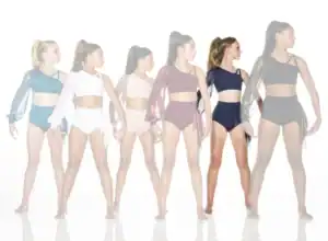 Six dancers model colorful asymmetrical two-piece dance costumes.