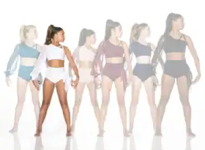 Six dancers model colorful asymmetrical dancewear against white background.