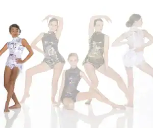 Five young dancers modeling abstract-patterned leotards on white background