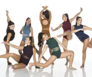 Six dancers pose in colorful leotards against white background.