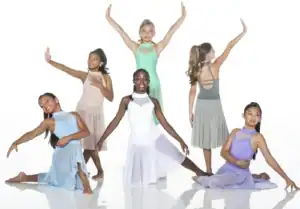 Six young dancers posing in pastel costumes on white background.