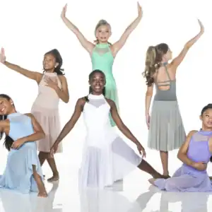 Six young dancers posing in pastel costumes on white background.