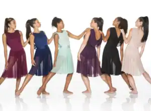 Six women model colorful chiffon dresses in a studio.