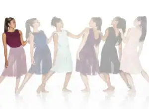 Six women in colorful dresses standing in a line