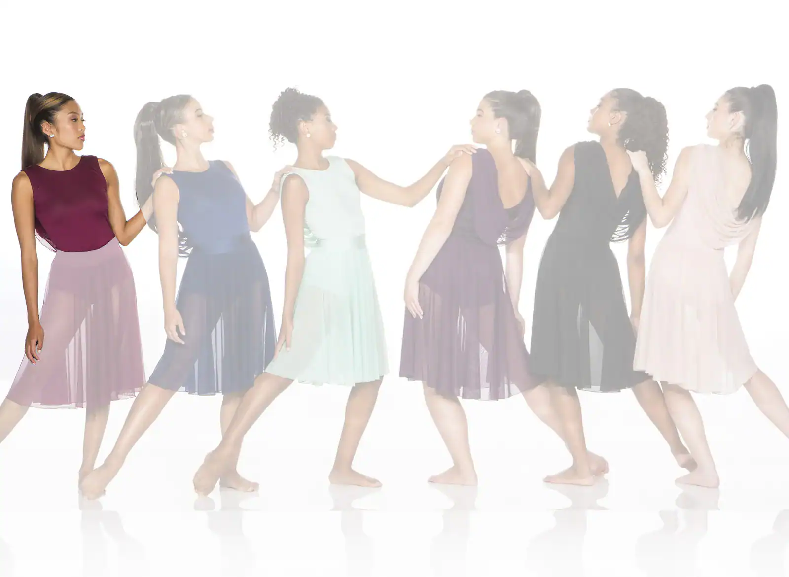 Six women in colorful dresses standing in a line