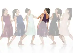 Six women in colorful dresses standing in a line