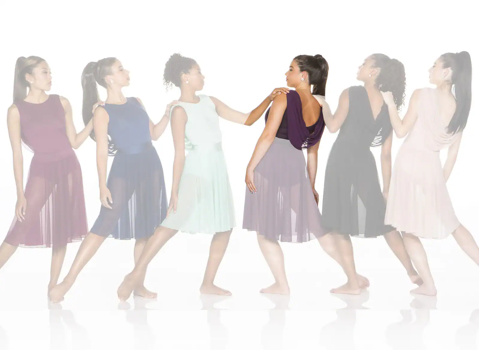 Six women in colorful dresses standing in a line