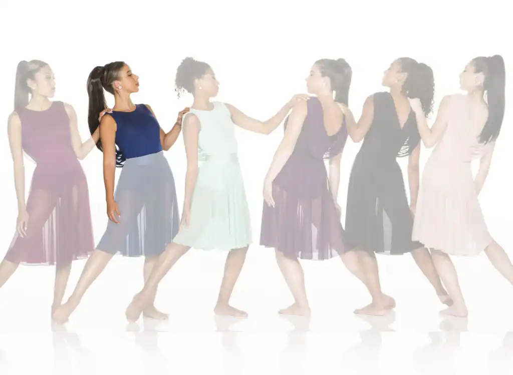 Six women in colorful dresses pose in a line