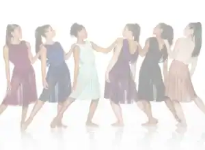 Six women in flowing dresses pose in a connected line.