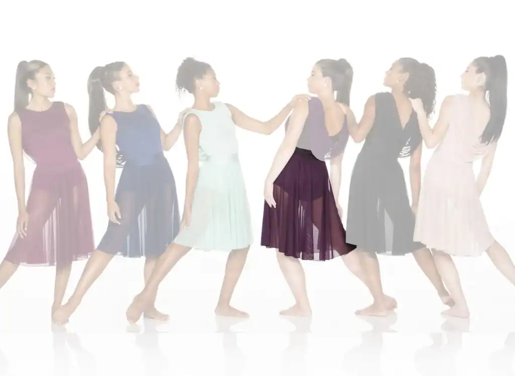 Six women in colorful flowing dresses walking in a line