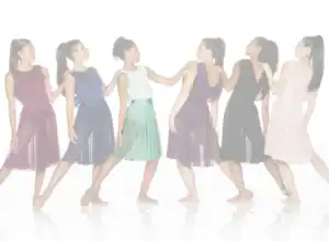 Six women modeling colorful sleeveless dresses in a studio