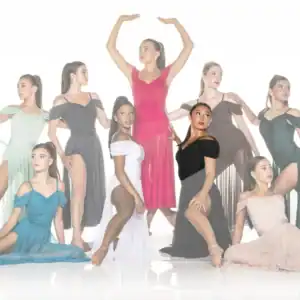 Nine dancers pose in colorful flowing dresses against white backdrop.