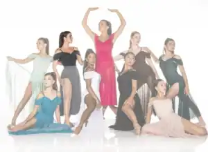 Eight dancers pose in colorful dresses against white background.