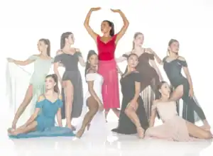 Nine dancers pose in colorful flowing costumes against white background.