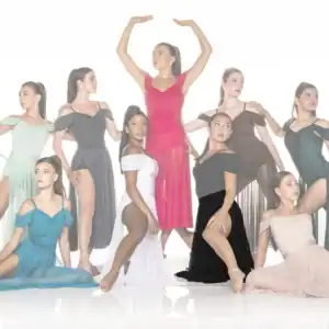 Nine dancers posing in colorful flowing dresses against white background